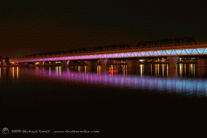Photograph of Metro Light Rail Bridge over Tempe Town Lake at night