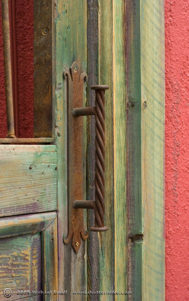 Photo of a green door and handle