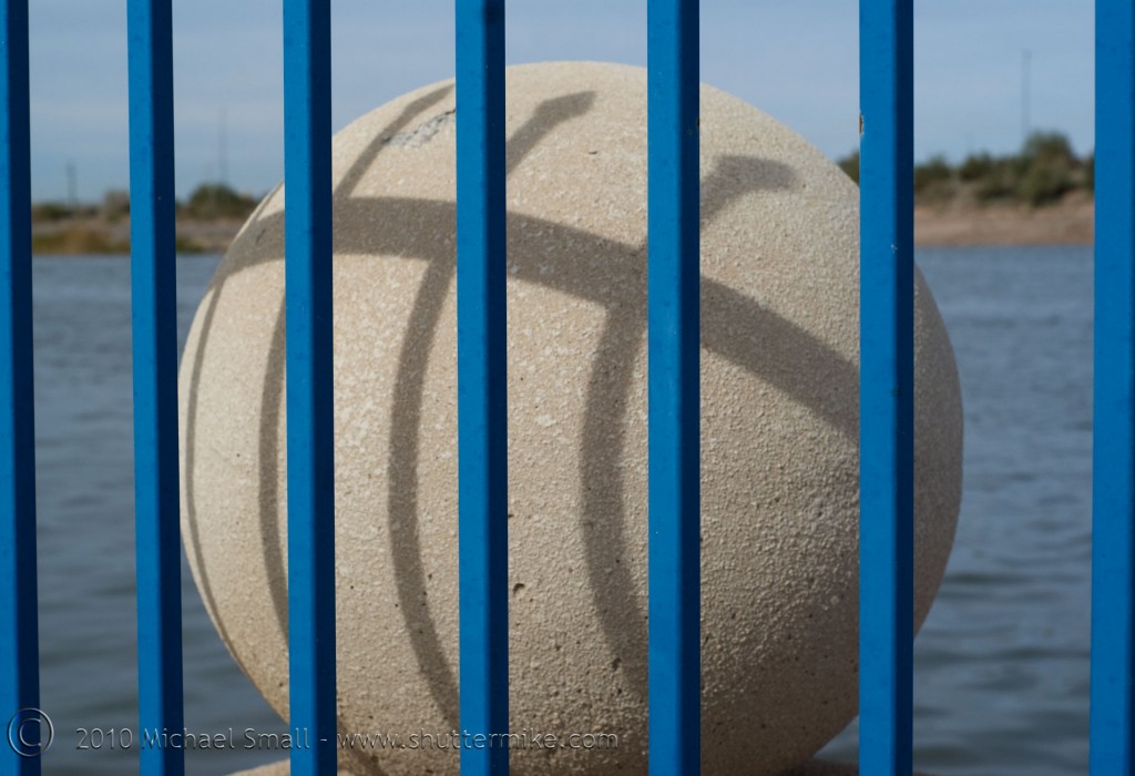 Photo of a concrete sphere behind blue bars in tempe, AZ