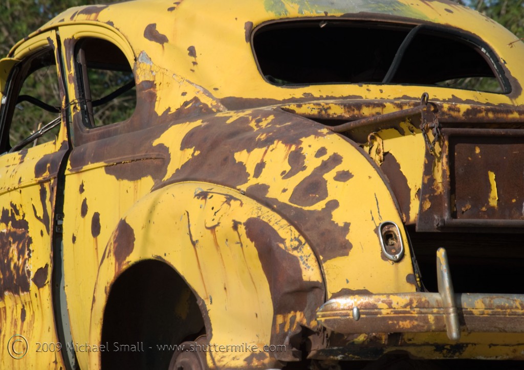 Photo of an old rusted yellow car