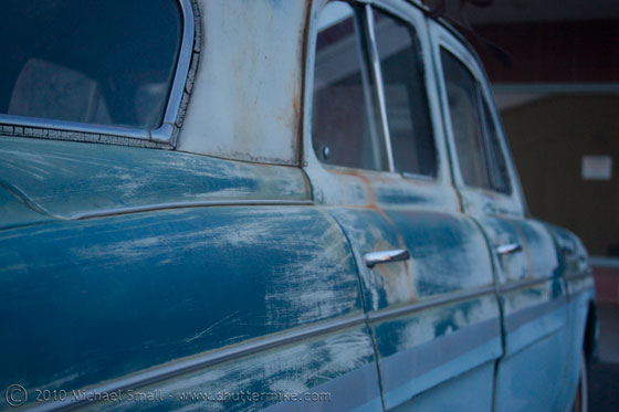 Photo of a well worn classic car.