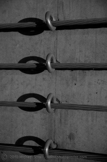 Detail photo of eye hooks and tension cables in a parking garage
