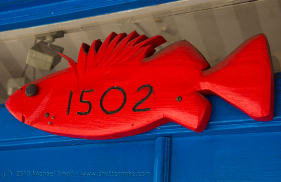 Photo of a wooden red fish address sign
