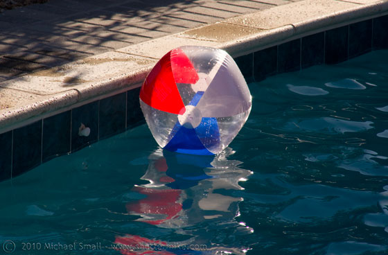 Photo of a beach ball floating in a pool