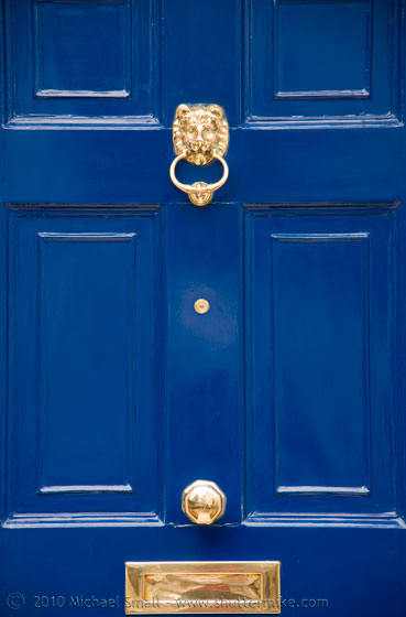 Photo of a blue door with knocker