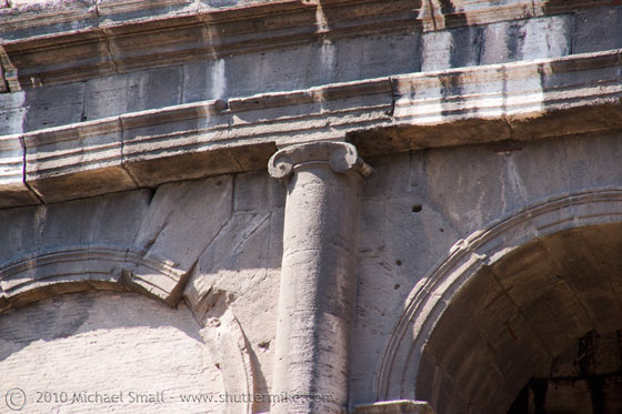 Photo of the ionic order columns of the colosseum in Rome