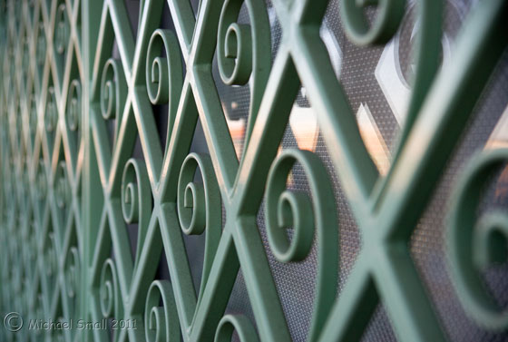 Photo of green iron work window covering