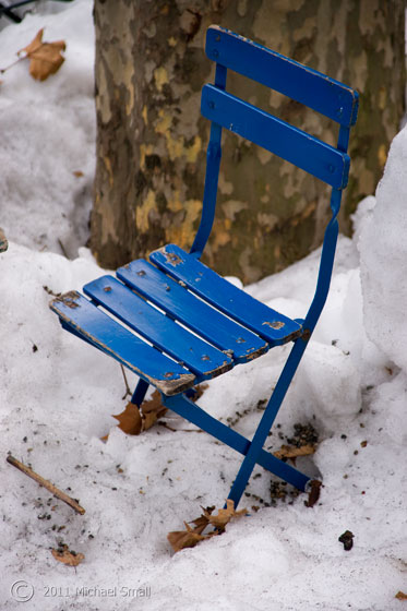 Photo of a blue child's chair in the snow