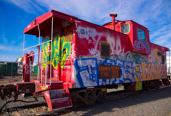 Photo of a graffiti tagged red caboose
