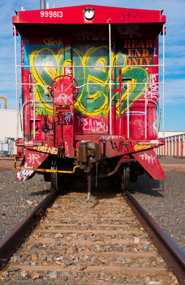 Photo of a caboose on railroad tracks