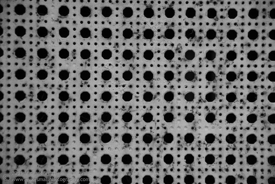 Black and white photograph of a ventilation grate.