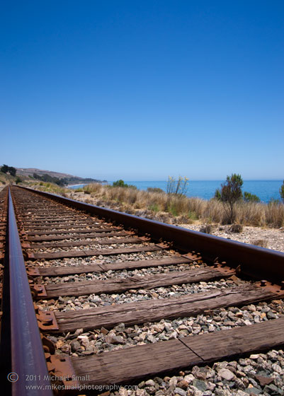 Photo of railroad tracks along the ocean in CA